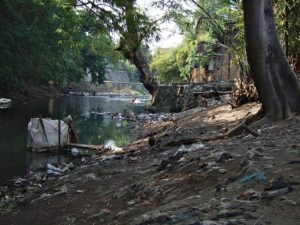 Lots of trash and a makeshift toilet along the river